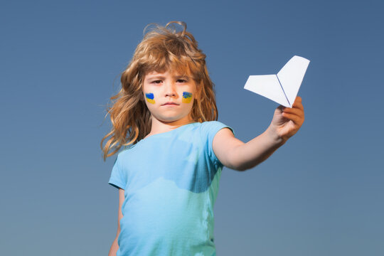 Close the sky over Ukraine banner. No fly zone over Ukraine. Ukraine flag on kids cheek. - Powered by Adobe