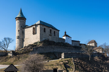 Medieval castle on top of the hill with tower and chapel against blue sky, Kuneticka hora, Czechia