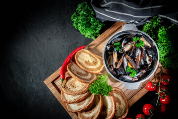 Delicious cooked seafood mussels with lemon and parsley. Clams in the shells and toasts