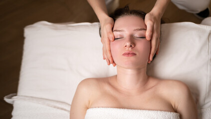 Face massage. Close-up of young woman getting spa massage treatment at beauty spa salon.Spa skin...