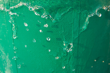 water flowing from a green bucket ,water background, green background