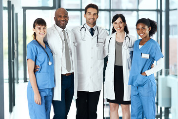 The best medical team a patient could hope for. Portrait of a diverse team of doctors standing...