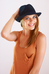 The hat compliments any outfit. A stylish young woman posing with a hat.