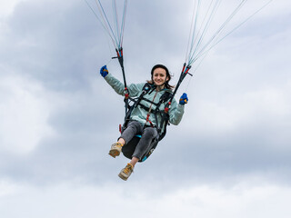 Naklejka na ściany i meble A girl flying a paraglider