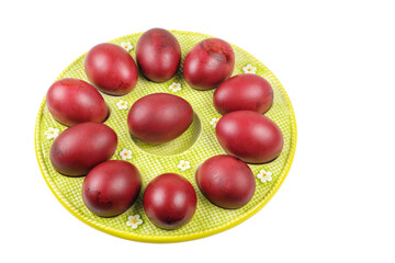 A plate of colored red Easter eggs isolated on a white background