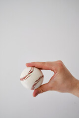 Baseball ball in the hands of a man. Baseball Match Day. Regular season games. Baseball league, team competition and championship. Baseball bat and ball. Sport party in United States. Professional