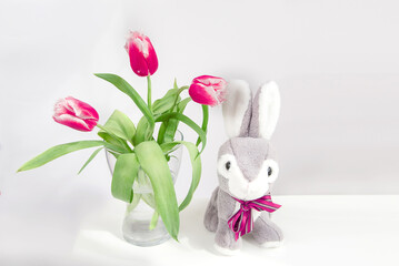 Red tulips flower and easter bunny on white