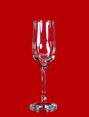 On a red background a beautiful glass for alcohol