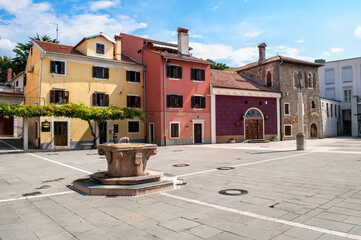 Small colorful houses and a cobbled square in the port city of Koper in Slovenia.