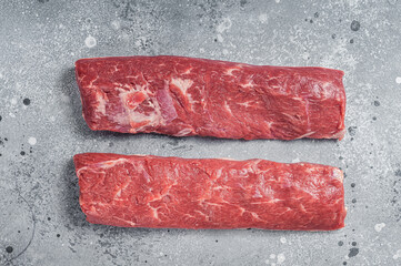Raw lamb tenderloin Fillet, Mutton Sirloin Meat on butcher table. Gray background. Top view