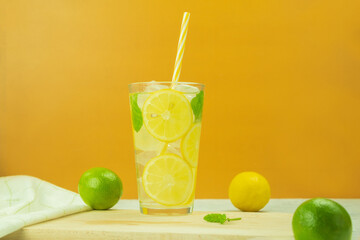 Cool lemonade from fresh lemons and mint on a yellow background