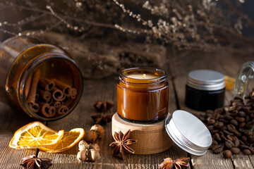 A set of different aroma candles in brown glass jars. Scented handmade candle. Soy candles are...