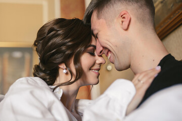 Fototapeta premium Gentle and romantic bride and groom in the morning in bed on the wedding day