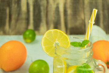 Fresh citrus lemonade with mint on a rustic background