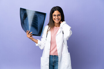 Young doctor woman holding a radiography laughing