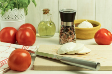 Fresh tomato and mozzarella on a wooden background