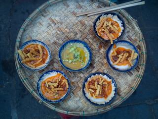 Bánh bèo (Steam Rice Cake) the famous street food of Hoi An, old town city. Must try menu for tourists. Steamed sticky rice cake with crispy dough with sweet and sour source.