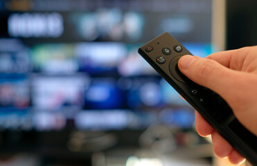 Remote control and screen - binge watching the favorite TV show