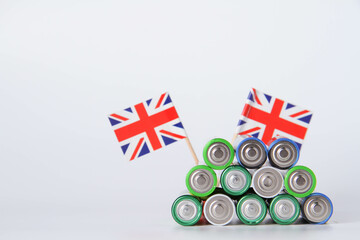 Battery. A lot of batteries on the background of the flag of the country.
