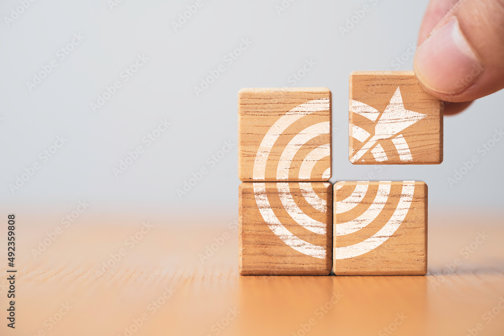 Aufkleber hand holding and assemble target board which print screen wooden block cube for create and setup bus