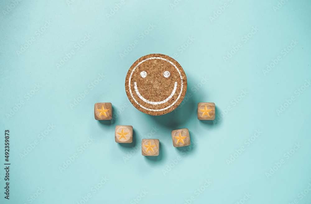 Aufkleber Smile face print screen on round  wooden block with golden five stars for client customer satisfaction after use product and service concept.
