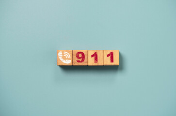 Emergency call concept , Telephone icon and number 911 print screen on wooden block cube on blue...