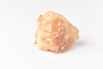 One  uncut and rough Sunstone crystal,quartz on white