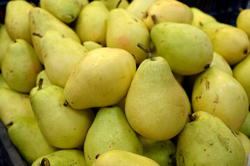 greengrocer, ripe pear,pear fruit ready for sale,light yellow pears in supermarket greengrocer aisle,