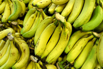 bananas in the greengrocer, a large amount of bananas on sale in the sales aisle,