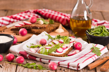 Rye bread with cottage cheese, radish and arugula.