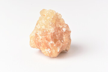One  uncut and rough Sunstone crystal,quartz on white