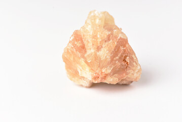 One  uncut and rough Sunstone crystal,quartz on white