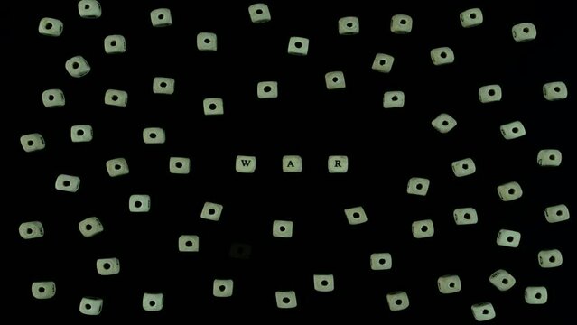 the word war made of white cubes on a black background with cubes with bullet holes gradually appearing around. stopmotion animatiom
