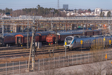 Panorama view over the railway yard in Solna with trains, catenaries and turn points a sunny day in...