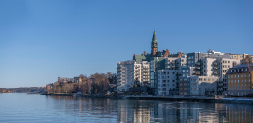 Old and new apartment houses at the waterfront Saltsjön in the district Nacka a sunny winter day in Stockholm