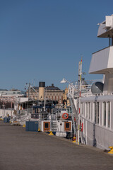 Fototapeta na wymiar Boats at the pier Skeppsbron a sunny day in Stockholm
