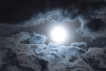 Naklejka na ściany i meble moon is rising between clouds at night