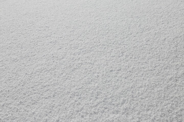 Snowdrift surface closeup as a white, snowy texture.