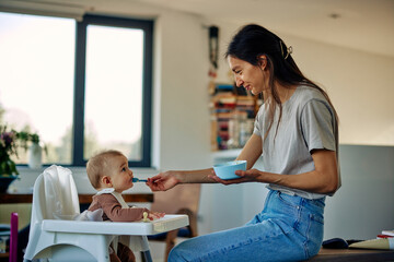 Happy baby and mother during lunchtime