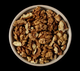 Obraz na płótnie Canvas Walnut kernels, pile isolated on white background, top view