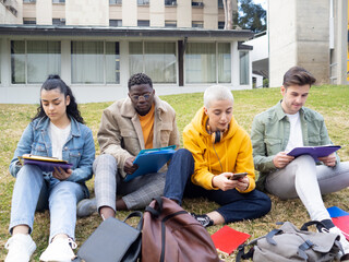 Group of multiethnic college students studying sitting on campus