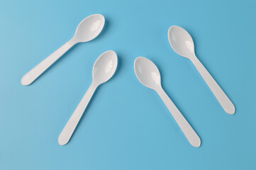 Plastic spoon isolated on a blue background