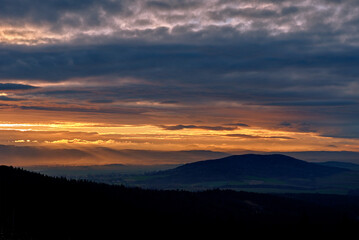 Sunset with dramatic cloudy sky over mountains shape, beautiful nature landscape