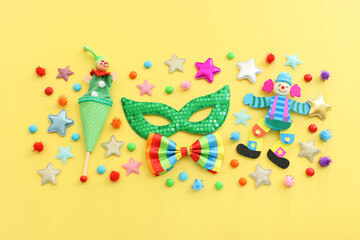 Holidays image of carnival party sequins masks over yellow background. view from above
