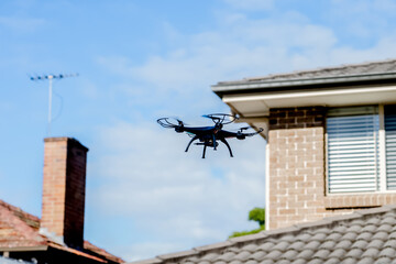 Drone camera quad copter flying over the roofs. Drone photography and videography. Drone flight.