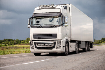 Blue truck on a road in summer