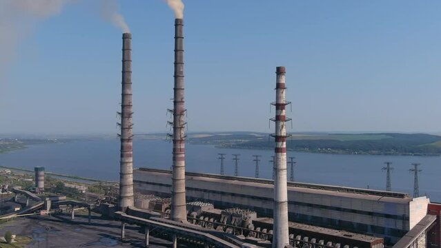 Environmental pollution. Smoke with harmful substances is ejected into the air of atmosphere through pipes of power station. Environmental disaster. Smoke coming from pipes a working chp