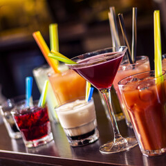 many colorful drinks on wooden table square