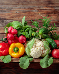 Raw vegetables on a wooden background.