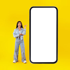 Happy lady pointing at mobile phone screen